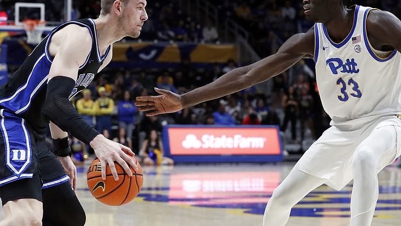 Jan 9, 2024; Pittsburgh, Pennsylvania, USA;  Duke Blue Devils center Kyle Filipowski (30) drives to the basket against Pittsburgh Panthers center Federiko Federiko (33) during the second half at the Petersen Events Center. Duke won 75-53. Mandatory Credit: Charles LeClaire-USA TODAY Sports