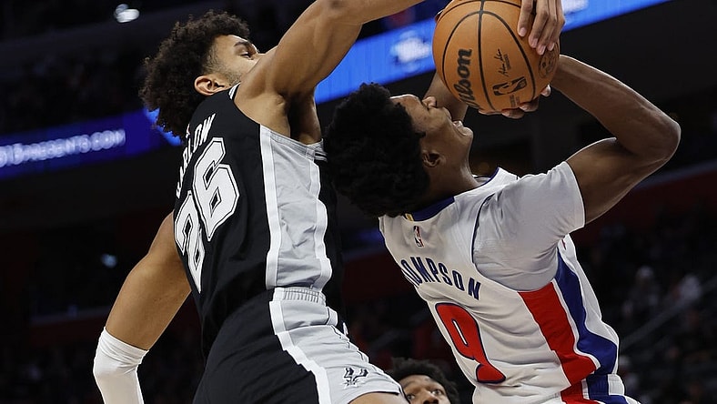 Jan 10, 2024; Detroit, Michigan, USA;  San Antonio Spurs forward Dominick Barlow (26) blocks a shot by Detroit Pistons forward Ausar Thompson (9) in the first half at Little Caesars Arena. Mandatory Credit: Rick Osentoski-USA TODAY Sports