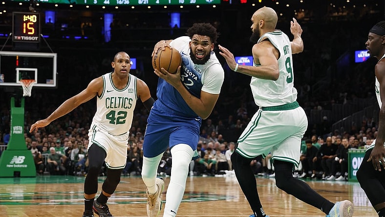 Jan 10, 2024; Boston, Massachusetts, USA; Minnesota Timberwolves center Karl-Anthony Towns (32) drives on Boston Celtics guard Derrick White (9) during the second quarter at TD Garden. Mandatory Credit: Winslow Townson-USA TODAY Sports