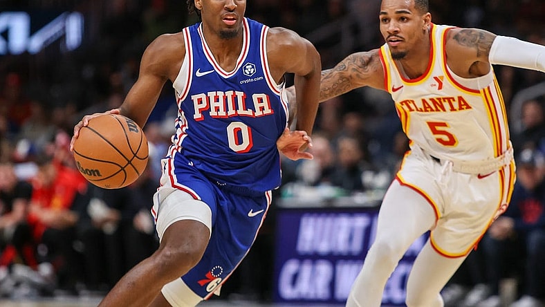 Jan 10, 2024; Atlanta, Georgia, USA; Philadelphia 76ers guard Tyrese Maxey (0) drives on Atlanta Hawks guard Dejounte Murray (5) in the first quarter at State Farm Arena. Mandatory Credit: Brett Davis-USA TODAY Sports