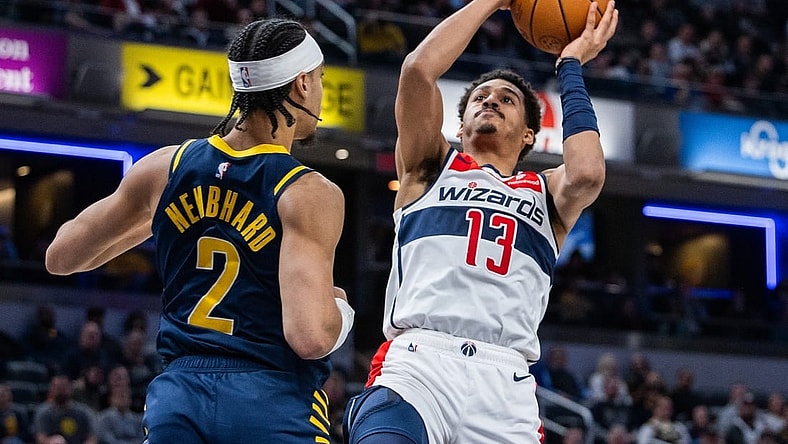 Jan 10, 2024; Indianapolis, Indiana, USA; Washington Wizards guard Jordan Poole (13) shoots the ball while Indiana Pacers guard Andrew Nembhard (2) defends in the first half at Gainbridge Fieldhouse. Mandatory Credit: Trevor Ruszkowski-USA TODAY Sports