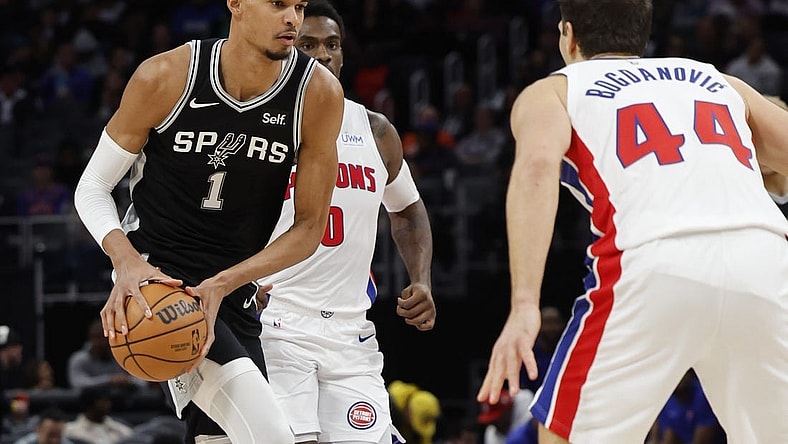 Jan 10, 2024; Detroit, Michigan, USA;  San Antonio Spurs center Victor Wembanyama (1) dribbles defended by Detroit Pistons forward Bojan Bogdanovic (44) in the first half at Little Caesars Arena. Mandatory Credit: Rick Osentoski-USA TODAY Sports