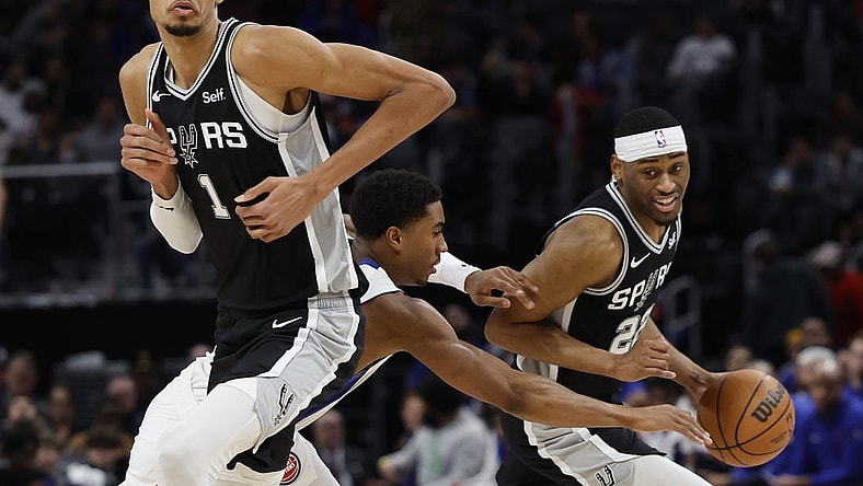 Jan 10, 2024; Detroit, Michigan, USA;  San Antonio Spurs guard Malaki Branham (22) dribbles off the pick by center Victor Wembanyama (1) defended by Detroit Pistons guard Jaden Ivey (23) in the second half at Little Caesars Arena. Mandatory Credit: Rick Osentoski-USA TODAY Sports