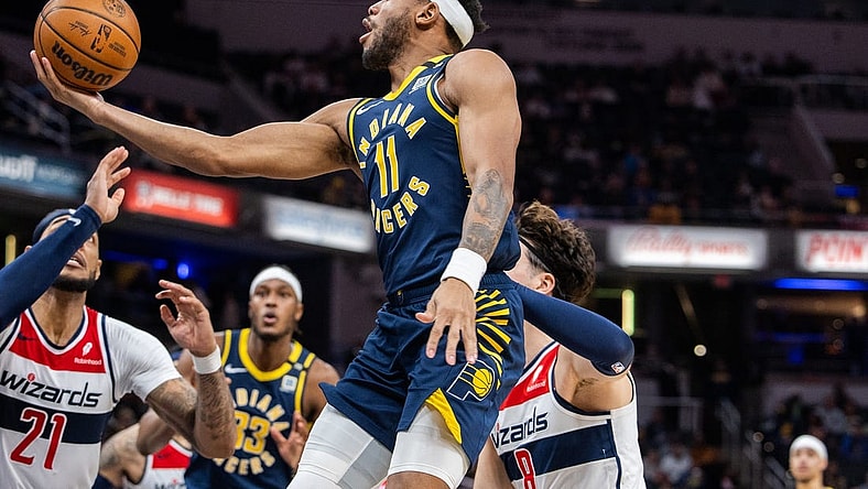 Jan 10, 2024; Indianapolis, Indiana, USA; Indiana Pacers forward Bruce Brown (11) shoots the ball while Washington Wizards forward Deni Avdija (8) defends in the second half at Gainbridge Fieldhouse. Mandatory Credit: Trevor Ruszkowski-USA TODAY Sports