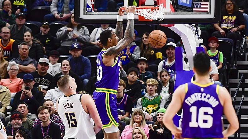 Jan 10, 2024; Salt Lake City, Utah, USA; Utah Jazz forward/center John Collins (20) dunks over Denver Nuggets center Nikola Jokic (15) during the first half at the Delta Center. Mandatory Credit: Christopher Creveling-USA TODAY Sports
