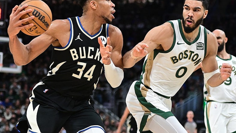 Jan 11, 2024; Milwaukee, Wisconsin, USA; Milwaukee Bucks forward Giannis Antetokounmpo (34) drives for the basket against Boston Celtics forward Jayson Tatum (0) in the second quarter at Fiserv Forum. Mandatory Credit: Benny Sieu-USA TODAY Sports