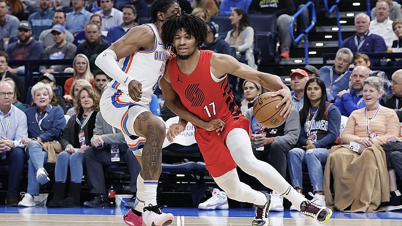 Jan 11, 2024; Oklahoma City, Oklahoma, USA; Portland Trail Blazers guard Shaedon Sharpe (17) drives around Oklahoma City Thunder forward Jalen Williams (8) during the second quarter at Paycom Center. Mandatory Credit: Alonzo Adams-USA TODAY Sports