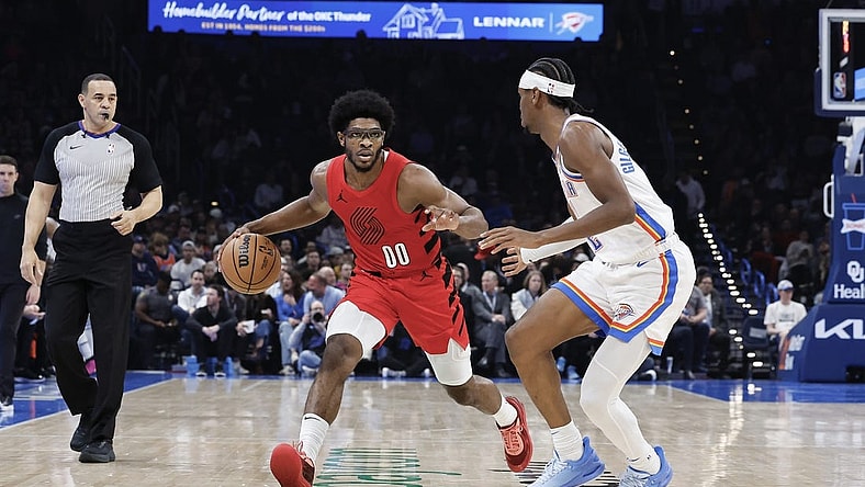 Jan 11, 2024; Oklahoma City, Oklahoma, USA; Portland Trail Blazers guard Scoot Henderson (00) drives down the court against Oklahoma City Thunder guard Shai Gilgeous-Alexander (2) during the second quarter at Paycom Center. Mandatory Credit: Alonzo Adams-USA TODAY Sports