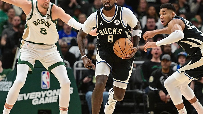 Jan 11, 2024; Milwaukee, Wisconsin, USA;  Milwaukee Bucks forward Bobby Portis (9) brings the ball down court against Boston Celtics center Kristaps Porzingis (8) in the second quarterat Fiserv Forum. Mandatory Credit: Benny Sieu-USA TODAY Sports