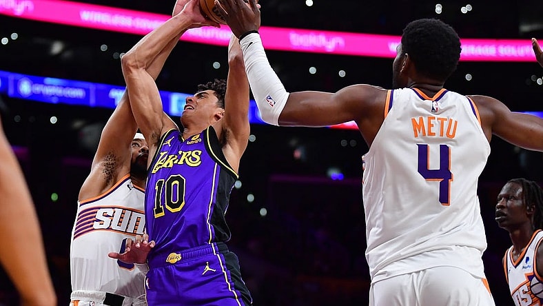 Jan 11, 2024; Los Angeles, California, USA; Los Angeles Lakers guard Max Christie (10) moves to the basket against Phoenix Suns guard Jordan Goodwin (0) and forward Chimezie Metu (4) during the second half at Crypto.com Arena. Mandatory Credit: Gary A. Vasquez-USA TODAY Sports