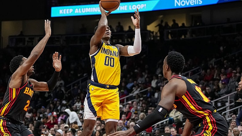 Jan 12, 2024; Atlanta, Georgia, USA; Indiana Pacers guard Bennedict Mathurin (00) shoots over Atlanta Hawks forward Onyeka Okongwu (17) during the first half at State Farm Arena. Mandatory Credit: Dale Zanine-USA TODAY Sports