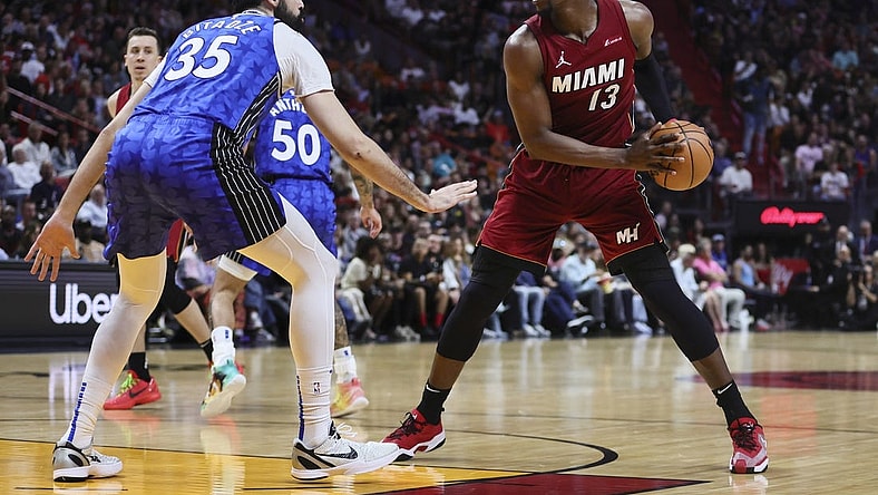 Jan 12, 2024; Miami, Florida, USA; Miami Heat center Bam Adebayo (13) protects the basketball from Orlando Magic center Goga Bitadze (35) during the second quarter at Kaseya Center. Mandatory Credit: Sam Navarro-USA TODAY Sports