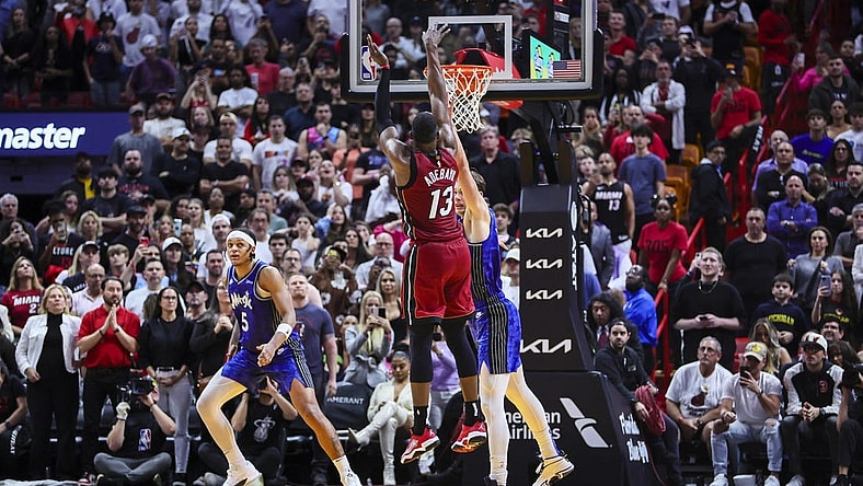 Jan 12, 2024; Miami, Florida, USA; Miami Heat center Bam Adebayo (13) scores against Orlando Magic center Moritz Wagner (21) during the fourth quarter at Kaseya Center. Mandatory Credit: Sam Navarro-USA TODAY Sports