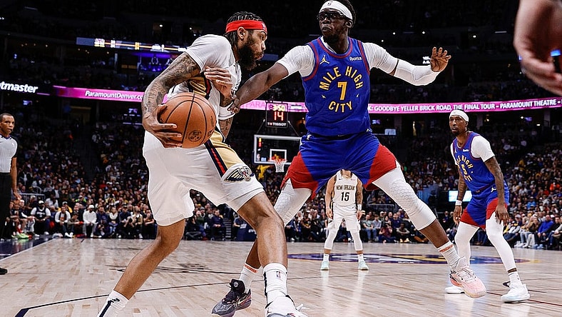 Jan 12, 2024; Denver, Colorado, USA; New Orleans Pelicans forward Brandon Ingram (14) controls the ball under pressure from Denver Nuggets guard Reggie Jackson (7) in the first quarter at Ball Arena. Mandatory Credit: Isaiah J. Downing-USA TODAY Sports