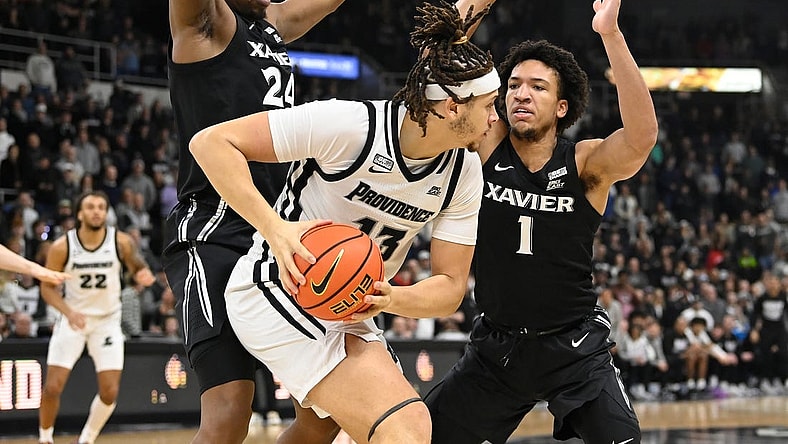 Jan 13, 2024; Providence, Rhode Island, USA; Providence Friars forward Josh Oduro (13) controls the ball against Xavier Musketeers guard Desmond Claude (1) during the first half at Amica Mutual Pavilion. Mandatory Credit:Eric Canha-USA TODAY Sports