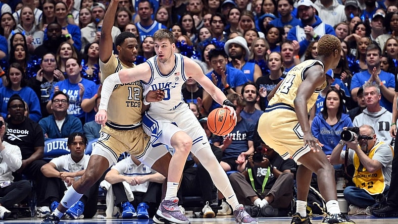 Jan 13, 2024; Durham, North Carolina, USA;  Duke Blue Devils center Kyle Filipowski (30) controls the ball against Georgia Tech Yellow Jackets foward Tyzhaun Claude (12)during the first half at Cameron Indoor Stadium. Mandatory Credit: Rob Kinnan-USA TODAY Sports