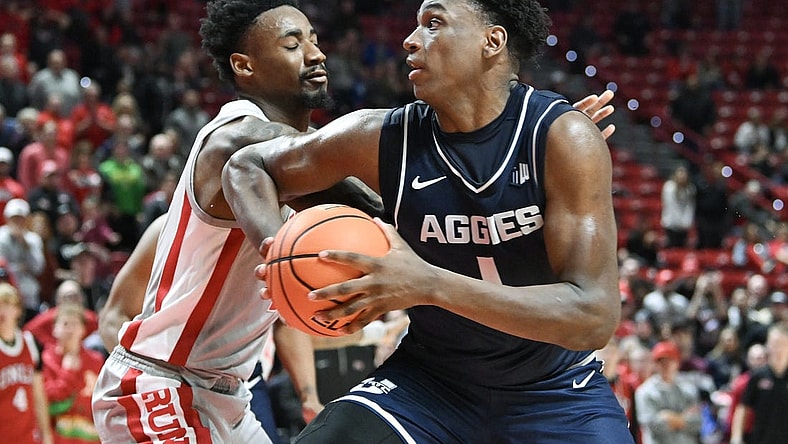 Jan 13, 2024; Las Vegas, Nevada, USA; Utah State Aggies forward Great Osobor (1) drives to the basket against UNLV Rebels forward Kalib Boone (10) in the second half at Thomas & Mack Center. Mandatory Credit: Candice Ward-USA TODAY Sports