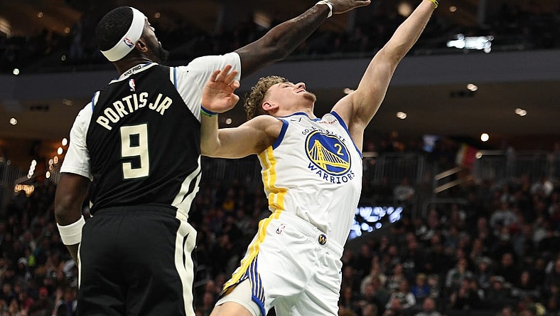 Jan 13, 2024; Milwaukee, Wisconsin, USA; Golden State Warriors guard Brandin Podziemski (2) puts up a shot against Milwaukee Bucks forward Bobby Portis (9) in the first half at Fiserv Forum. Mandatory Credit: Michael McLoone-USA TODAY Sports