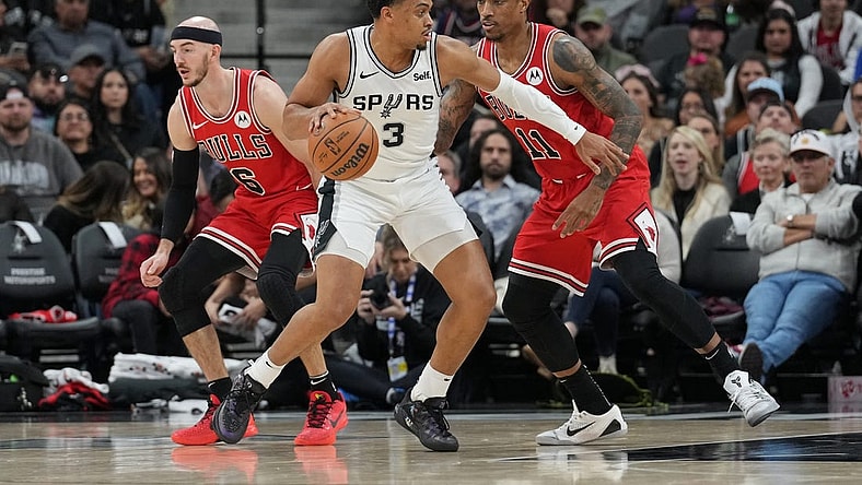 Jan 13, 2024; San Antonio, Texas, USA;  San Antonio Spurs forward Keldon Johnson (3) dribbles against Chicago Bulls forward DeMar DeRozan (11) in the first half at Frost Bank Center. Mandatory Credit: Daniel Dunn-USA TODAY Sports