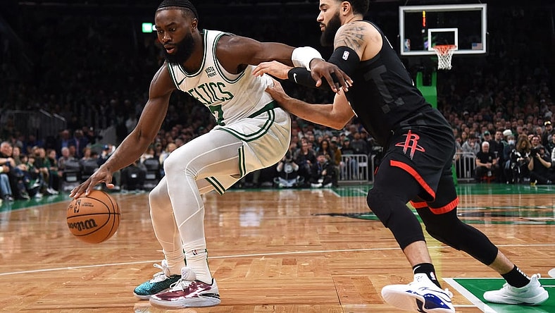 Jan 13, 2024; Boston, Massachusetts, USA; Boston Celtics guard Jaylen Brown (7) controls the ball while Houston Rockets guard Fred VanVleet (5) defends during the first half at TD Garden. Mandatory Credit: Bob DeChiara-USA TODAY Sports