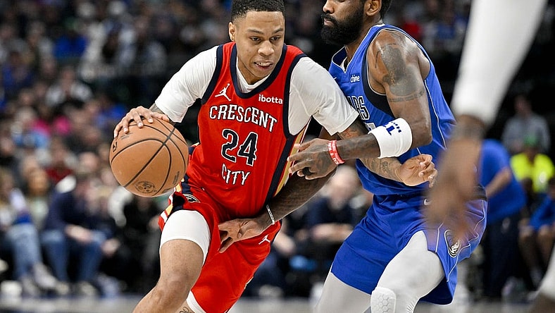 Jan 13, 2024; Dallas, Texas, USA; New Orleans Pelicans guard Jordan Hawkins (24) drives to the basket past Dallas Mavericks guard Kyrie Irving (11) during the second half at the American Airlines Center. Mandatory Credit: Jerome Miron-USA TODAY Sports