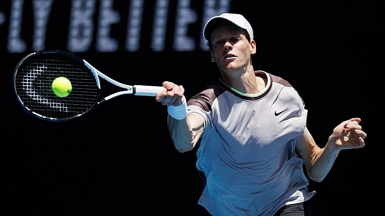 Jan 14, 2024; Melbourne, Victoria, Australia;   Jannik Sinner of Italy hits a shot against Botic Van De Zandschulp of the Netherlands in the first round of the men s singles. Mandatory Credit: Mike Frey-USA TODAY Sports