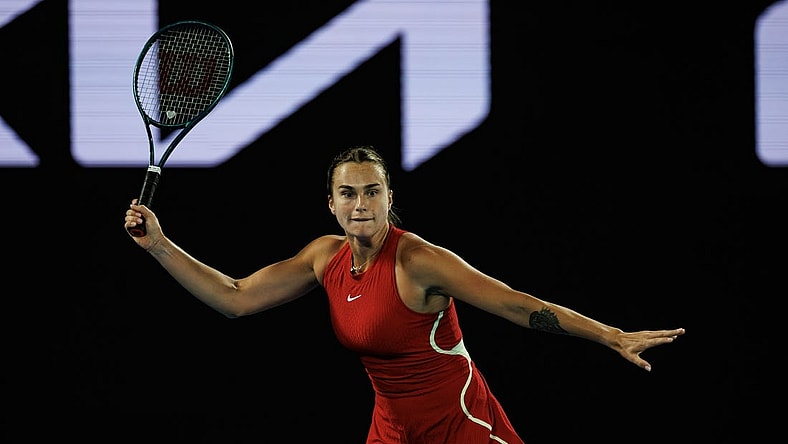 Jan 14, 2024; Melbourne, Victoria, Australia;  Aryna Sabalenka of Russia hits a shot against Ella Seidel of Germany in the first round of the women s singles. Mandatory Credit: Mike Frey-USA TODAY Sports