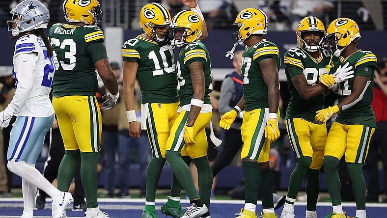 Jan 14, 2024; Arlington, Texas, USA; Green Bay Packers quarterback Jordan Love (10) reacts with wide receiver Dontayvion Wicks (13) after a touchdown catch in the first half of the 2024 NFC wild card game at AT&T Stadium. Mandatory Credit: Kevin Jairaj-USA TODAY Sports
