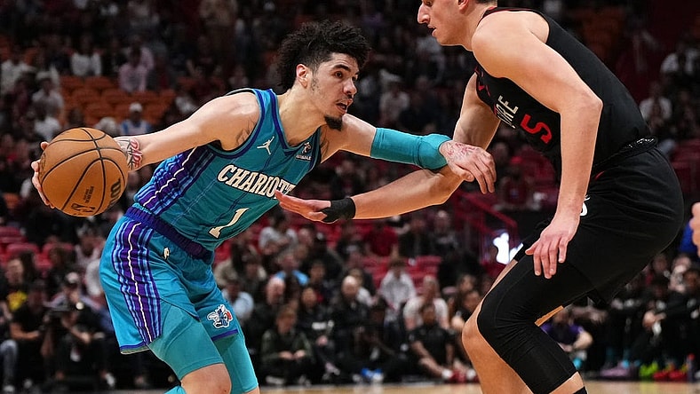 Jan 14, 2024; Miami, Florida, USA; Charlotte Hornets guard LaMelo Ball (1) drives the ball around Miami Heat forward Nikola Jovic (5) during the first half at Kaseya Center. Mandatory Credit: Jasen Vinlove-USA TODAY Sports