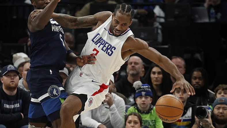 Jan 14, 2024; Minneapolis, Minnesota, USA; Minnesota Timberwolves guard Anthony Edwards (5) defends against Los Angeles Clippers forward Kawhi Leonard (2) in the first quarter at Target Center. Mandatory Credit: Bruce Kluckhohn-USA TODAY Sports