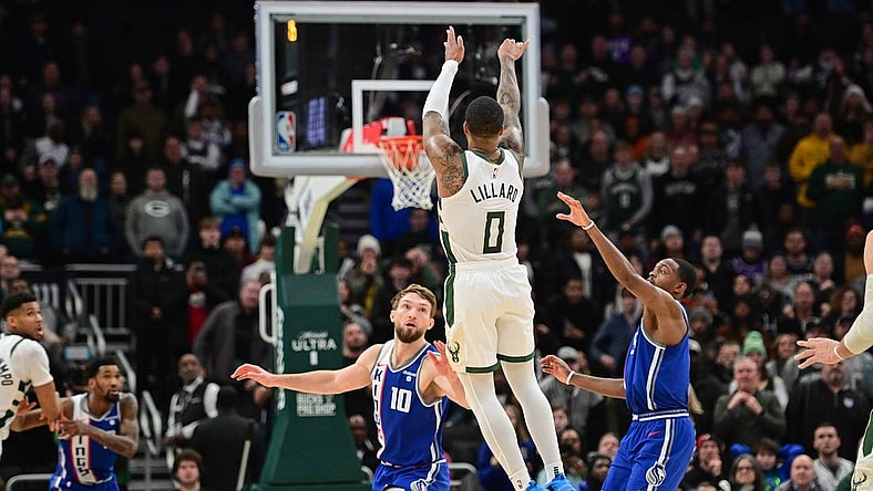Jan 14, 2024; Milwaukee, Wisconsin, USA; Milwaukee Bucks guard Damian Lillard (0) scores the game-winning three-point basket at the end of overtime against the Sacramento Kings at Fiserv Forum. Mandatory Credit: Benny Sieu-USA TODAY Sports