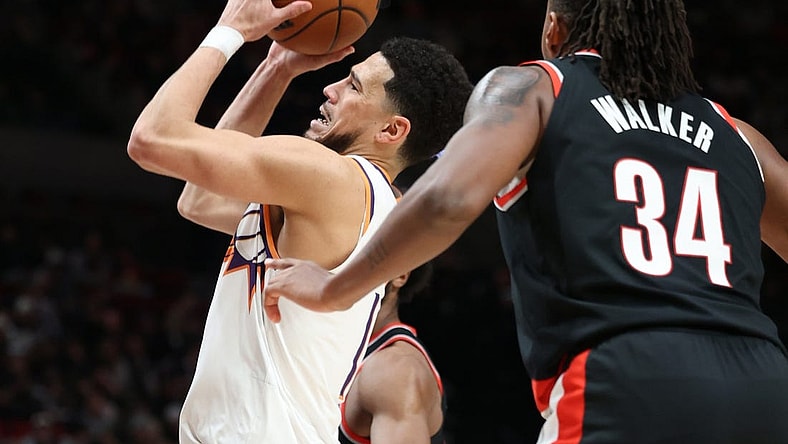 Jan 14, 2024; Portland, Oregon, USA;  Phoenix Suns guard Devin Booker (1) shoots the ball over Portland Trail Blazers forward Jabari Walker (34) in the third quarter at Moda Center. Mandatory Credit: Jaime Valdez-USA TODAY Sports