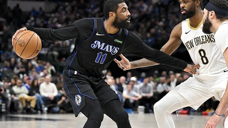 Jan 15, 2024; Dallas, Texas, USA; Dallas Mavericks guard Kyrie Irving (11) looks to move the ball past New Orleans Pelicans forward Naji Marshall (8) during the second quarter at the American Airlines Center. Mandatory Credit: Jerome Miron-USA TODAY Sports