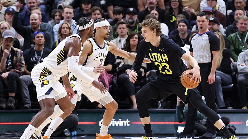 Jan 15, 2024; Salt Lake City, Utah, USA; Utah Jazz forward Lauri Markkanen (23) looks to drive against Indiana Pacers guard Buddy Hield (7) and guard Andrew Nembhard (2) during the second quarter at Delta Center. Mandatory Credit: Rob Gray-USA TODAY Sports