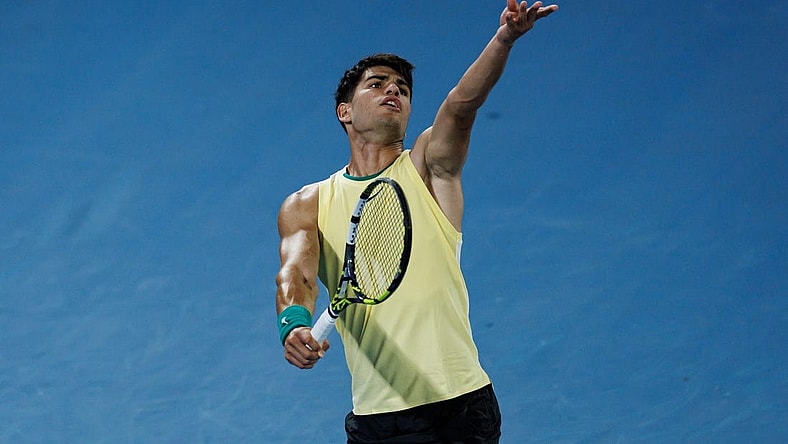 Jan 16, 2024; Melbourne, Victoria, Australia;   Carlos Alcaraz of Spain hits a shot against Richard Gasquet of France in the first round of the men s singles at the Australian Open. Mandatory Credit: Mike Frey-USA TODAY Sports