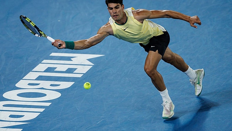 Jan 16, 2024; Melbourne, Victoria, Australia;   Carlos Alcaraz of Spain hits a shot against Richard Gasquet of France in the first round of the men s singles at the Australian Open. Mandatory Credit: Mike Frey-USA TODAY Sports