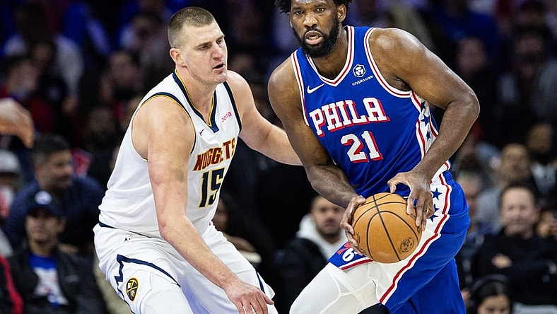 Jan 16, 2024; Philadelphia, Pennsylvania, USA; Philadelphia 76ers center Joel Embiid (21) controls the ball against Denver Nuggets center Nikola Jokic (15) during the first quarter at Wells Fargo Center. Mandatory Credit: Bill Streicher-USA TODAY Sports