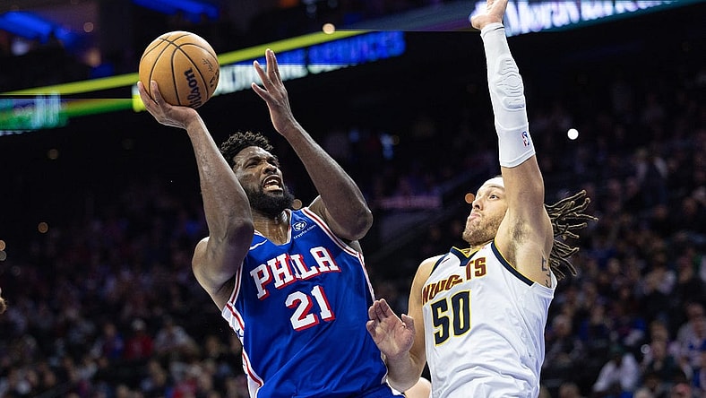 Jan 16, 2024; Philadelphia, Pennsylvania, USA; Philadelphia 76ers center Joel Embiid (21) drives for a shot against Denver Nuggets forward Aaron Gordon (50) during the fourth quarter at Wells Fargo Center. Mandatory Credit: Bill Streicher-USA TODAY Sports