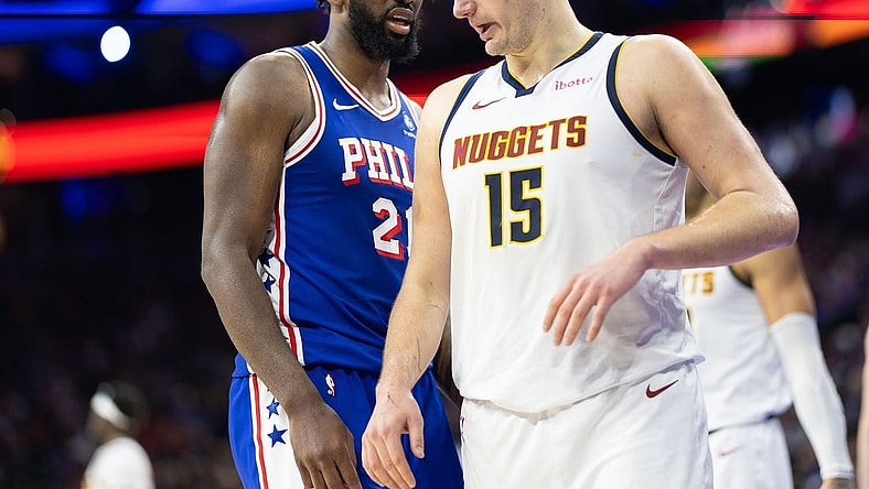 Jan 16, 2024; Philadelphia, Pennsylvania, USA; Philadelphia 76ers center Joel Embiid (21) glances at Denver Nuggets center Nikola Jokic (15) during a break in action in the third quarter at Wells Fargo Center. Mandatory Credit: Bill Streicher-USA TODAY Sports