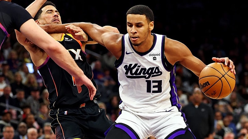 Jan 16, 2024; Phoenix, Arizona, USA; Sacramento Kings forward Keegan Murray (13) drives to the basket against Phoenix Suns guard Devin Booker (1) during the third quarter at Footprint Center. Mandatory Credit: Mark J. Rebilas-USA TODAY Sports
