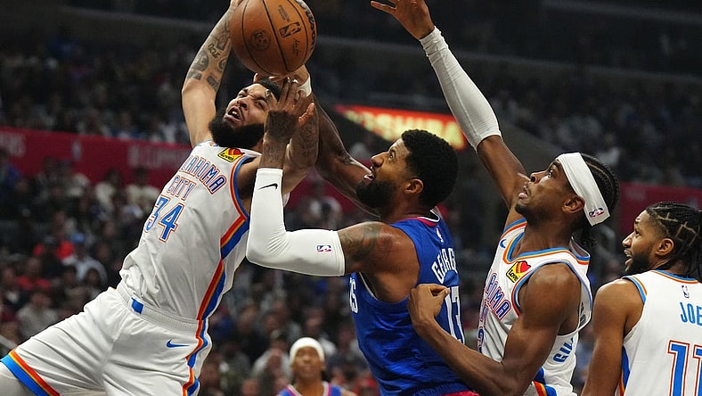 Jan 16, 2024; Los Angeles, California, USA; Oklahoma City Thunder forward Kenrich Williams (34) and guard Shai Gilgeous-Alexander (2) battle for the ball with LA Clippers forward Paul George (13) in the first half at Crypto.com Arena. Mandatory Credit: Kirby Lee-USA TODAY Sports
