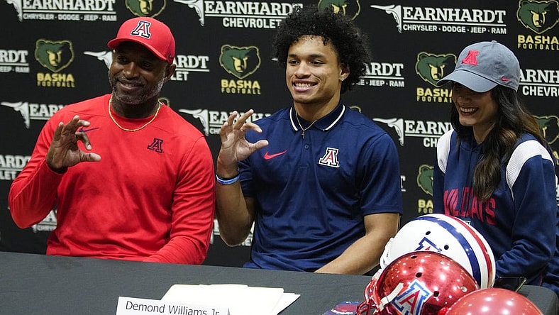 Basha quarterback Demond Williams poses for pictures after signing his letter of intent to play for University of Arizona during the NLI signing at Basha High School in Chandler on Dec. 20, 2023.