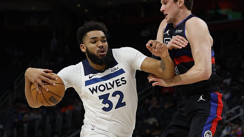 Jan 17, 2024; Detroit, Michigan, USA;  Minnesota Timberwolves center Karl-Anthony Towns (32) is defended by Detroit Pistons forward MikeMuscala (41) in the first half at Little Caesars Arena. Mandatory Credit: Rick Osentoski-USA TODAY Sports
