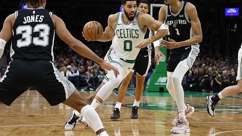 Jan 17, 2024; Boston, Massachusetts, USA; Boston Celtics forward Jayson Tatum (0) drives past San Antonio Spurs center Victor Wembanyama (1) during the second quarter at TD Garden. Mandatory Credit: Winslow Townson-USA TODAY Sports