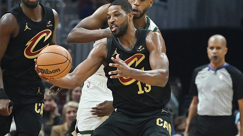 Jan 17, 2024; Cleveland, Ohio, USA; Milwaukee Bucks forward Khris Middleton (22) goes for a loose ball against Cleveland Cavaliers center Tristan Thompson (13) during the first half at Rocket Mortgage FieldHouse. Mandatory Credit: Ken Blaze-USA TODAY Sports