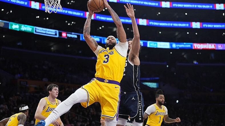 Jan 17, 2024; Los Angeles, California, USA; Los Angeles Lakers forward Anthony Davis (3) rebounds the ball against Dallas Mavericks center Dereck Lively II (2) in the first half at Crypto.com Arena. Mandatory Credit: Kirby Lee-USA TODAY Sports