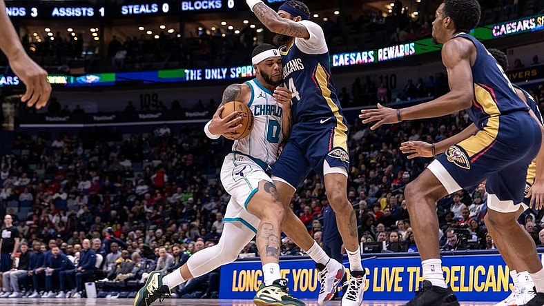 Jan 17, 2024; New Orleans, Louisiana, USA; Charlotte Hornets forward Miles Bridges (0) dribbles against New Orleans Pelicans forward Brandon Ingram (14) during the second half at Smoothie King Center. Mandatory Credit: Stephen Lew-USA TODAY Sports