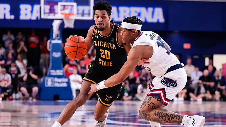 Jan 18, 2024; Boca Raton, Florida, USA; Wichita State Shockers guard Harlond Beverly (20) dribbles the ball against Florida Atlantic Owls guard Alijah Martin (15) during the first half at Eleanor R. Baldwin Arena. Mandatory Credit: Rich Storry-USA TODAY Sports