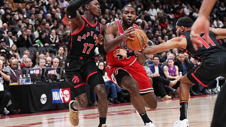Jan 18, 2024; Toronto, Ontario, CAN; Chicago Bulls forward Patrick Williams (44) controls the ball between Toronto Raptors guard Dennis Schroder (17) and guard Bruce Brown (11) during the third quarter at Scotiabank Arena. Mandatory Credit: Nick Turchiaro-USA TODAY Sports
