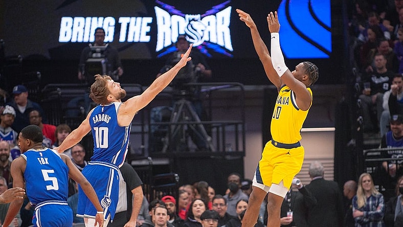 Jan 18, 2024; Sacramento, California, USA; Indiana Pacers guard Bennedict Mathurin (00) takes a shot over Sacramento Kings forward Domantas Sabonis (10) during the first quarter at Golden 1 Center. Mandatory Credit: Ed Szczepanski-USA TODAY Sports